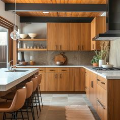 a kitchen with wooden cabinets and white counter tops