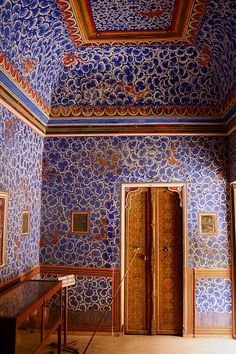 an ornate room with blue and red walls