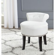 a white chair sitting on top of a rug