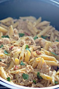 pasta with tuna and spinach in a blue pot