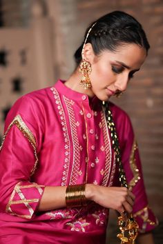 Hot pink kurta with gold, silver zari thread and bead embroidery in floral pattern on yoke. Paired with gota border embroidered salwar and potli. - Aza Fashions Ceremonial Lehenga With Dabka Work For Diwali, Festive Mirror Work Traditional Wear For Diwali, Traditional Kundan Sets With Dabka Work, Festive Traditional Wear With Mirror Work For Diwali, Traditional Festive Sets With Dabka Work, Traditional Gold Palazzo Set With Zari Work, Traditional Raw Silk Palazzo Set For Festive Occasions, Ceremonial Sharara With Dabka Work, Ceremonial Lehenga With Dabka Work For Eid