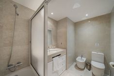 a bathroom with a toilet, sink and bathtub next to a walk in shower