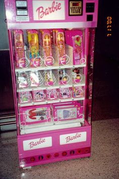 a pink vending machine sitting on top of a counter