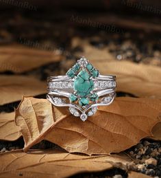 an image of a beautiful ring with turquoise stones on the top and diamonds in the bottom