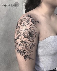 a woman with a flower tattoo on her arm