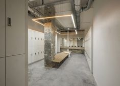 an empty room with benches and lockers