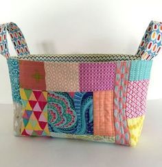 a multicolored patchwork purse with handles