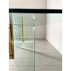 an empty room with a glass door and white tile flooring that has been painted gold