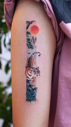 a woman's arm with a tiger tattoo on the left side of her body