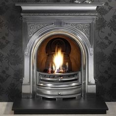 a fireplace with a fire burning in it's mantle and wallpapered walls