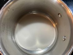 the bottom of a metal pot with water in it