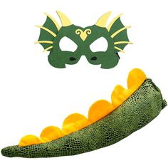 a green dragon mask and oranges in front of a white background with an image of a yellow dragon's head