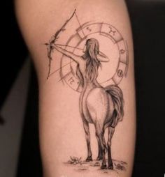 a woman with a bow and arrow on her arm