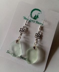 Dangly earrings made from sea glass found on our local beach in Scotland. Each piece of seaglass is unique, and finding an exact pair, impossible!  These fragments of glass are beautifully smooth from their time in the sea and are similar in shape and size, measuring approx. 1cm in length.   The earrings have a drop of 6cm.  The glass pieces are small so they are very light to wear. The glass is drilled by hand.  The earrings are a silver plated fishhook design.  Not suitable for babies or young Beach Earrings With Sea Glass And Ear Wire, Beach Sea Glass Earrings With Ear Wire, White Recycled Glass Jewelry For The Beach, Handmade White Sea Glass Jewelry, Beach Earrings In Silver With Recycled Glass, Silver Sea Glass Earrings For Beach, Silver Recycled Glass Earrings For The Beach, Silver Recycled Glass Beach Earrings, Beach Silver Earrings With Recycled Glass