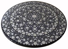 a black and white plate with flowers on it