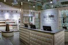 the inside of a jewelry store with chandeliers and lights hanging from the ceiling