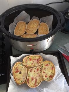 four mini pizzas are in the crock pot and ready to go into the slow cooker