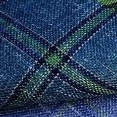 a blue tie with green and white designs on it's side, in close up