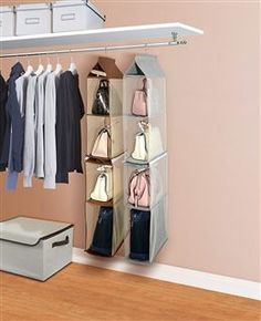 an organized closet with clothes, handbags and purses hanging on the wall above it