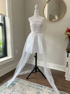 Elevate your bridal look with our Open Front One Layer Tulle Train Detachable Skirt. The snap buttons provide easy removal while the horse hair netting trim maintains the skirt's elegant structure. Complete with a stunning bridal belt and buttons. Perfect for the modern bride who wants to transform her wedding dress for an affordable price. Hair Netting, Detachable Wedding Skirt, Reception Looks, Wedding Train, Tulle Train, Detachable Skirt, Reception Look, Wedding Skirt, Wedding Veils Lace