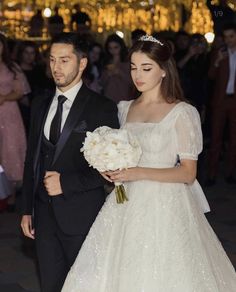 the bride and groom are walking down the aisle