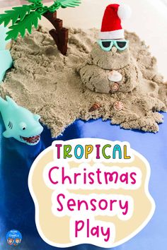 there is a christmas sand play in the shape of a beach with a santa hat and sunglasses on it