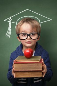 a young boy holding an apple and books with the words, the 1 thing my children need to be successful