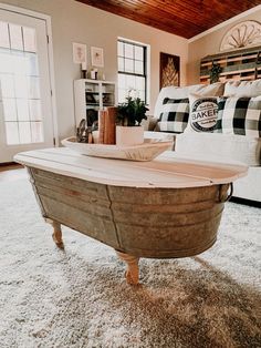 a living room with a couch, coffee table and rugs on the carpeted floor