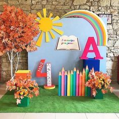 the colorful display includes books, crayons, and trees