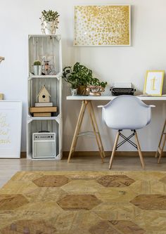 a white desk and chair with plants on it in a living room next to a bookcase