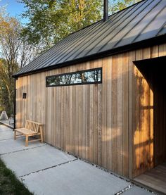 a wooden building with a bench in front of it