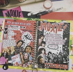 an open notebook with various images and words on it next to a keychain