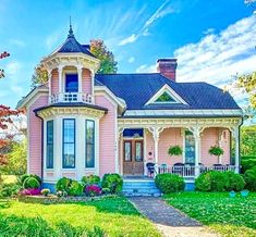 a pink house with a blue roof and white trim