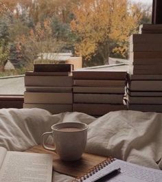 a cup of coffee and some books on a table