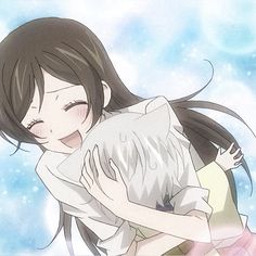 an anime character hugging another character in front of the sky with snow flakes behind her