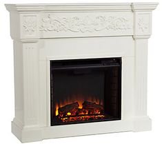 a white fireplace with a fire in it