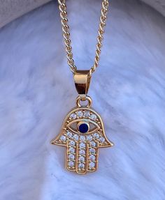 Hamsa Evil Eye Charm pendant  Necklace,  CZ stones on Hamsa Hand   Brazilian Gold Layered, Great Quality  Measures 20 inches in length Gold Plated Jeweled Necklaces As Gifts, Gold Chain Necklace With Rhinestones As Gift, Gold Chain Necklace With Rhinestones For Gift, Hand Set Gold Crystal Necklace, Gold Jeweled Chain Necklace Gift, Gold Crystal Charm Necklaces, Gold Crystal Necklace With Rhinestones And Cubic Zirconia, Gold Cubic Zirconia Crystal Necklace With Rhinestones, Gold Jeweled Crystal Necklace As A Gift