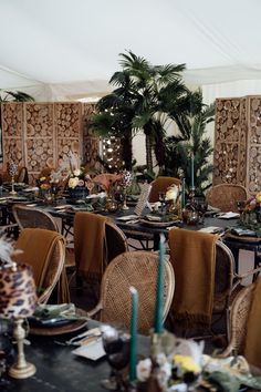 a dining room set up for a party with palm trees in the backgroun