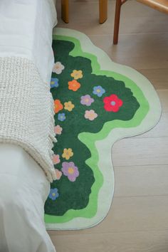 a white bed sitting next to a green rug