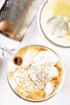 an overhead view of a drink in a glass with ice and cinnamon on the rim