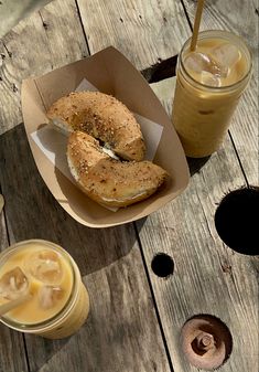 two donuts and drinks on a wooden table