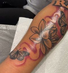 a woman's arm with butterflies on it and the word love written in black ink