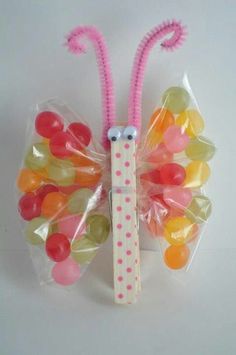 a butterfly made out of gummy bears in a plastic bag on a white surface