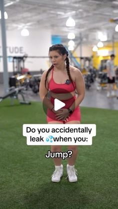 a woman in a red sports bra and white tennis shoes standing on grass with the words do you accidentally leak when you jump?