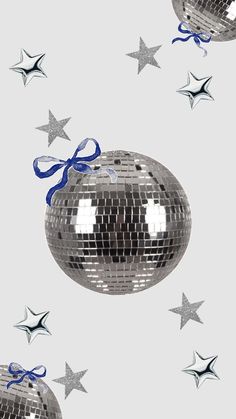 silver disco ball with blue ribbon and stars in the background