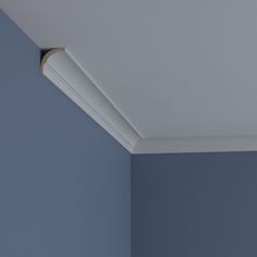 the corner of a blue room with a light fixture on it's ceiling and a wall in the background