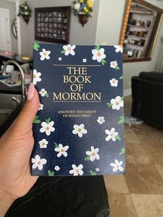 the book of mormon is being held up