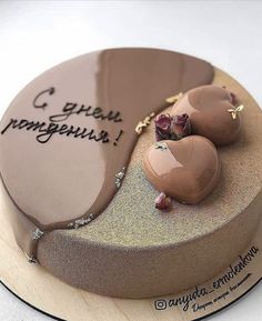 there is a cake decorated with chocolates on the top and writing on the bottom