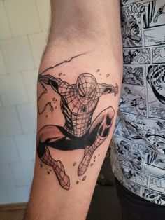 a man with a spiderman tattoo on his arm