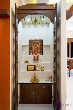 an open doorway leading to a bathroom with pictures on the wall and artwork above it